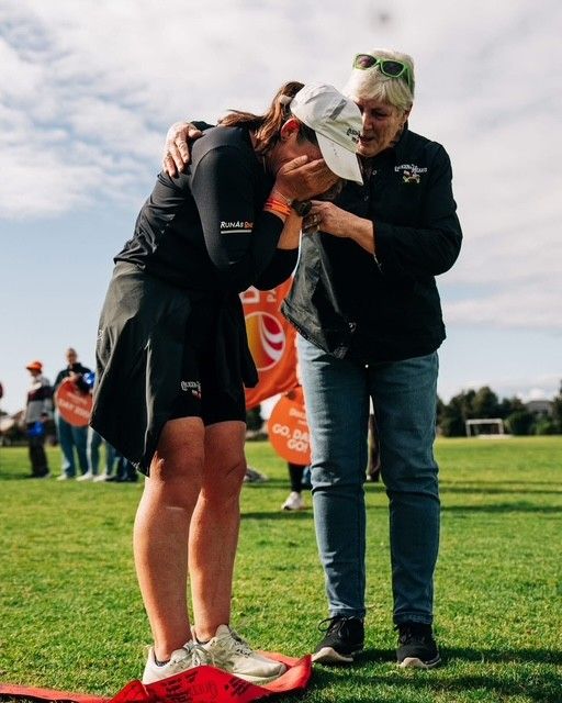 Dawn embracing her mother Janet at the finish line of the Queen of Hearts Run & Ride
